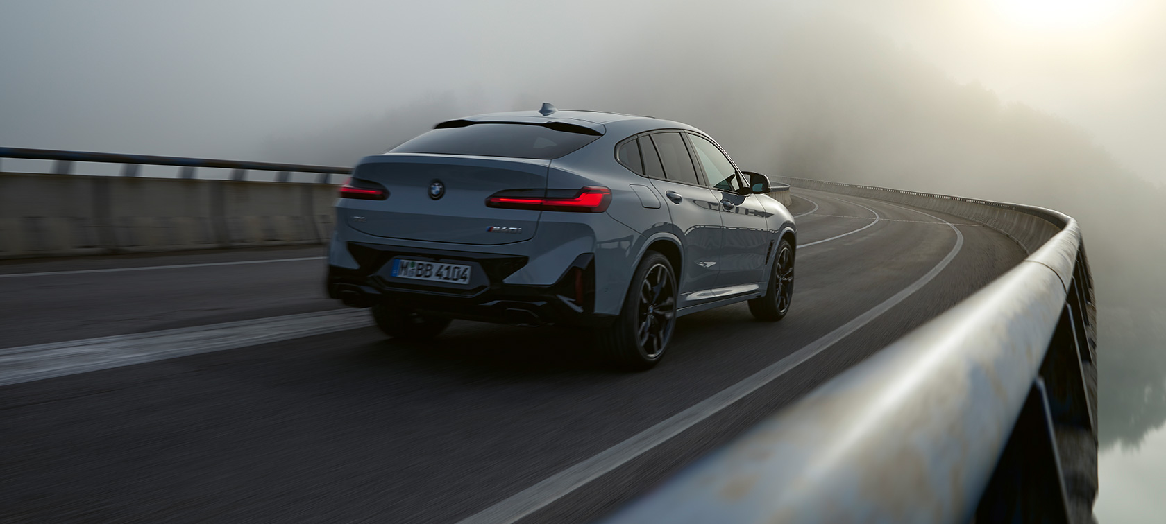 BMW X4 G02 Financial Services Brooklyn Grey three-quarter rear view driving 2021
